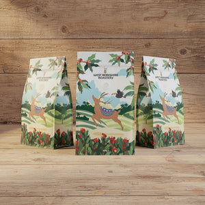 Colorful coffee bag with nature-themed design on a wooden surface