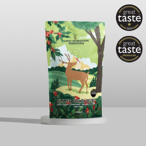 Coffee package with deer illustration and 'Great Taste' awards on a white background