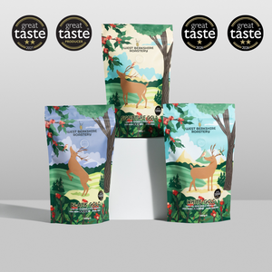 Four stand-up pouches of West Berkshire Honeybee products arranged on a light gray background, with four black 'great taste award 2024' badges displayed above. The honeybee packages feature a colorful forest illustration with a deer and red flowers.